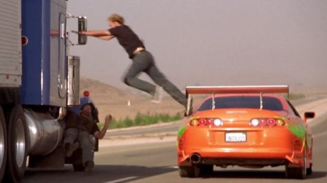 Paul Walker’s character from the original film The Fast and The Furious,  jumping from his car to a truck, just like the heists currently happening