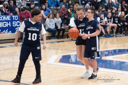 Three OHS Unified basketball players dribble down the court during Pack the Gym.