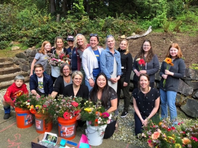 Volunteers help assemble flower bouquets for The Mayday Foundation’s fundraiser in 2019. 