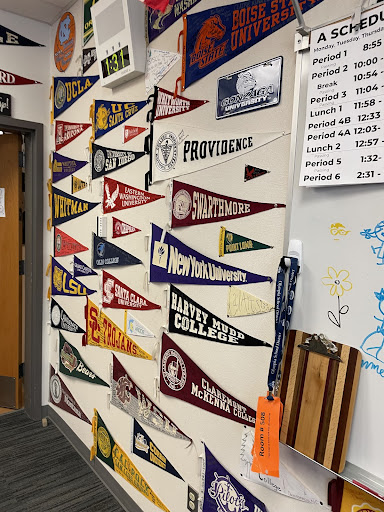 Mr. Schaefer displays penants from colleges attended by OHS alumni.