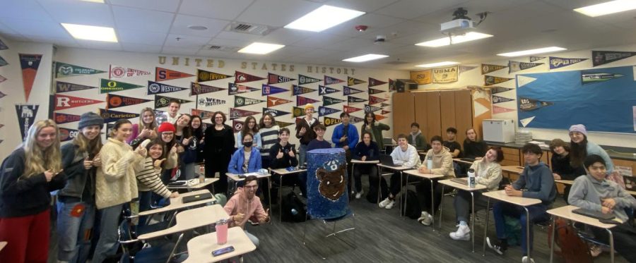 Mr. Schaefers class poses with the big can after winning the daily cans per student total.