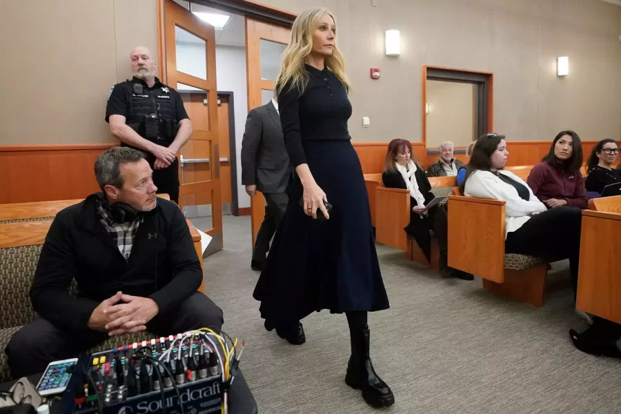 Paltrow, age 50, channeling her rich mom persona in a black polo shirt, long navy skirt, and $1,450 Prada boots.