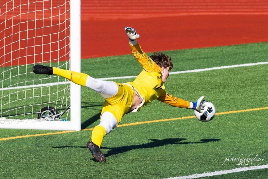 Jackson reaches for the ball as he protects his goal. Photo courtesy of: John OLeary