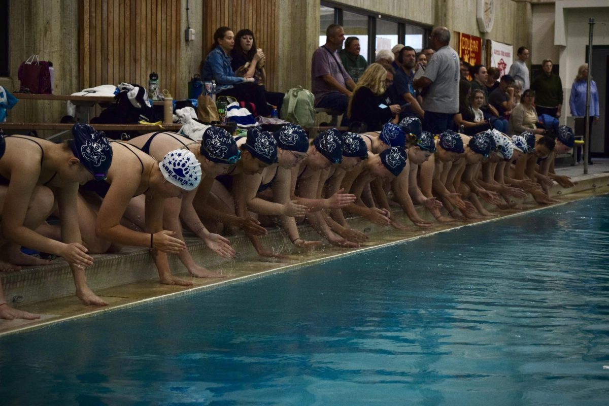 The girls do their traditional “gutter cheer” before the meet 