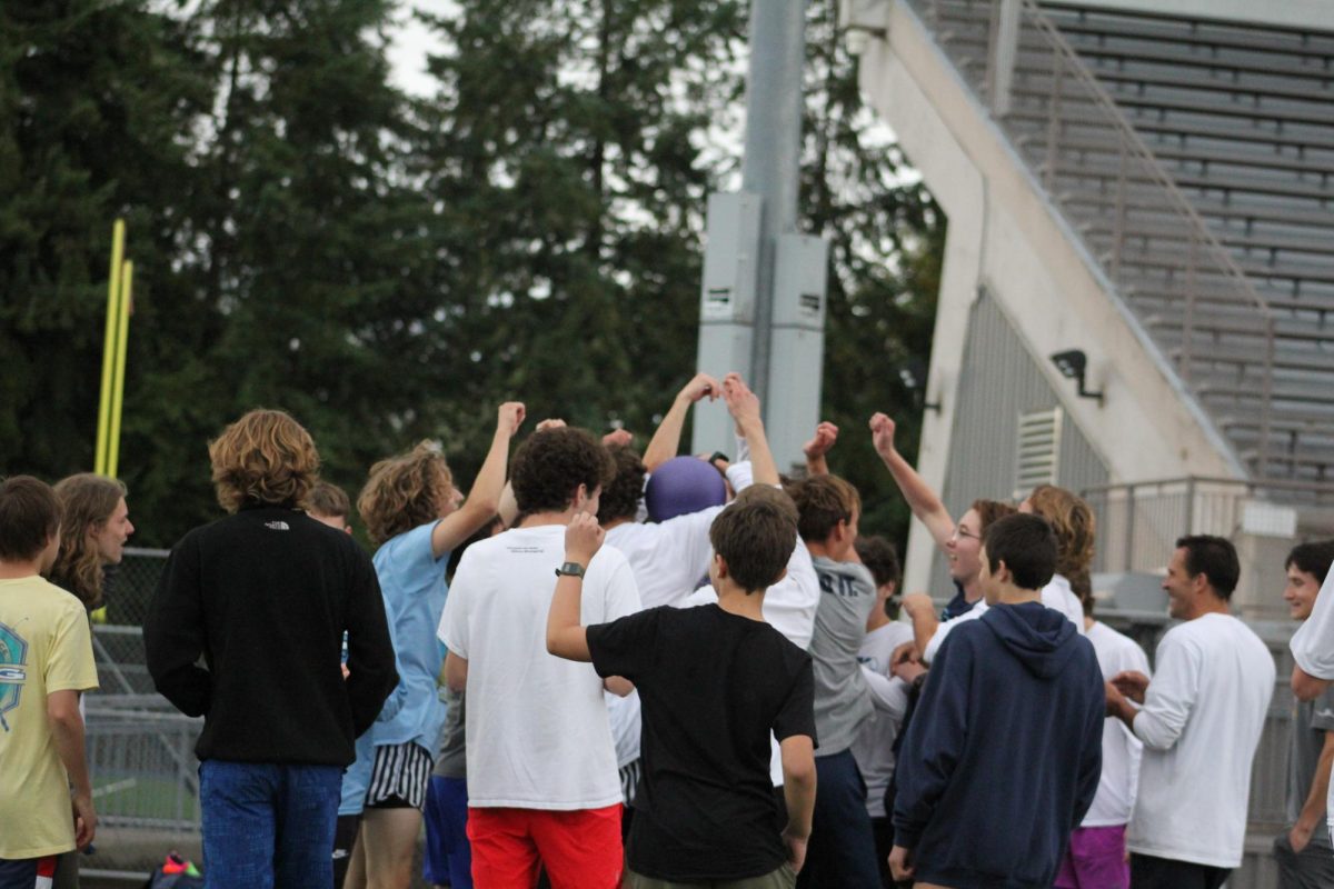 The Cross Country team celebrates after the last out of the game is recorded