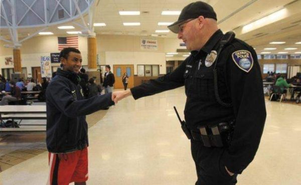 Former School Resource Officer Doug Curtright shakes hands with an OHS student. Photo courtesy of Keep a School Resource Officer at OHS on Facebook.