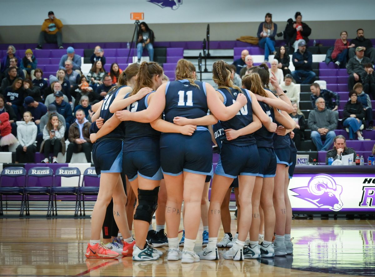 The girls huddle to prepare for the start of their game against the North Thurston Rams.