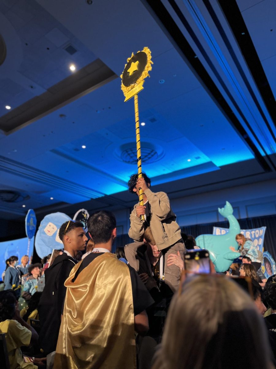 Opening Session spirit battle: D38's spirit stick is lifted up in the midst of a district chant. OHS, Timberline, CHS, and North Thurston are a few schools in D38.
