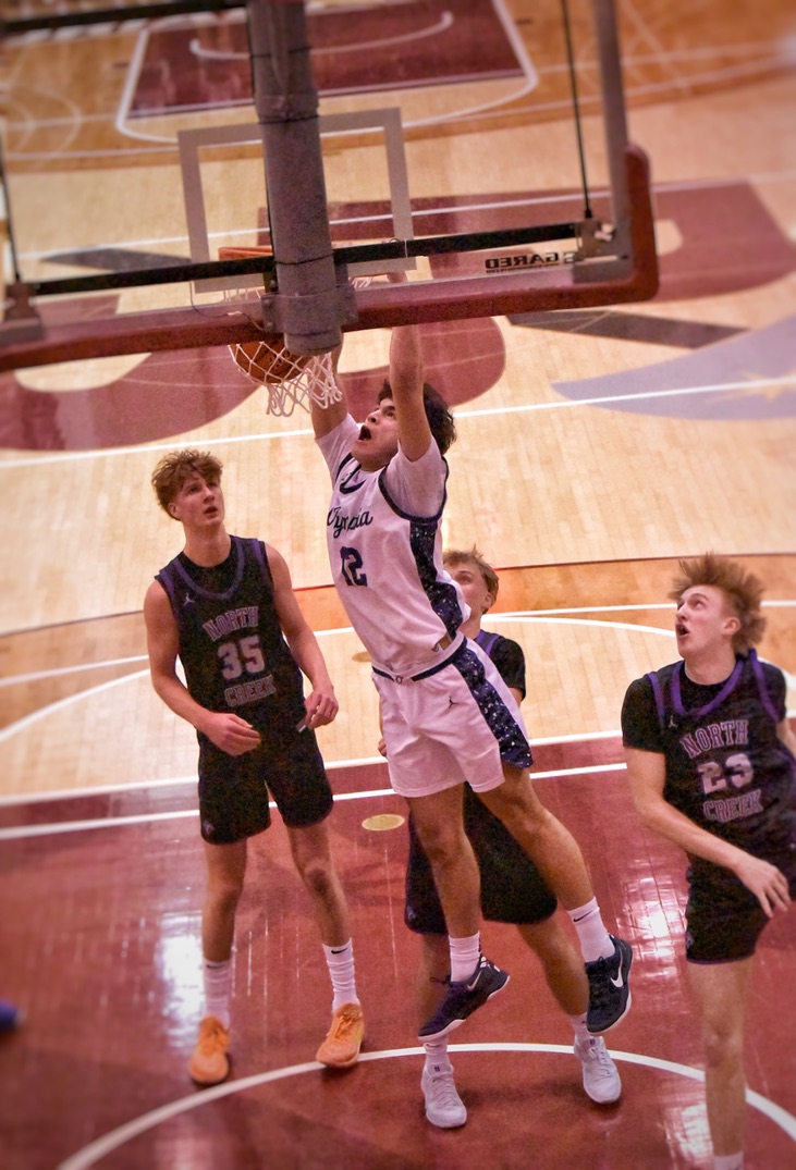 Sophomore Brian Stevenson slams down a dunk over the North Creek defense. Photo by Caleb Wilson.