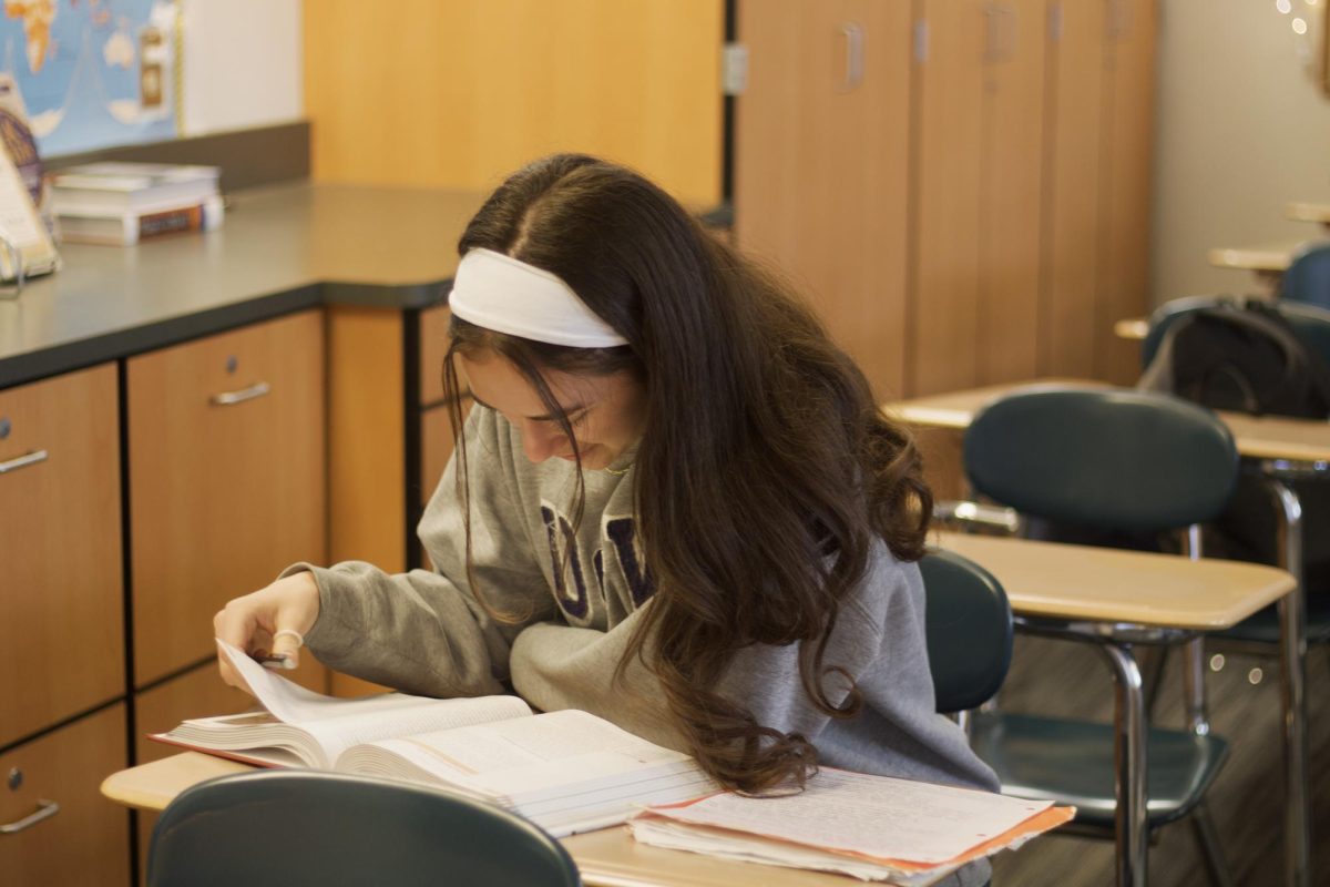 Lyra Neff doing her daily AP World notes, a time consuming task that "helps [her] understand the material and do well in the class." Photo by Kelly Giang.