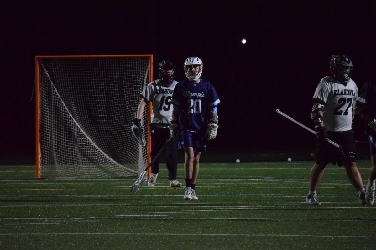 Under the glow of stadium lights, Luke Tedder pushes froward as defenders drift into position around him.