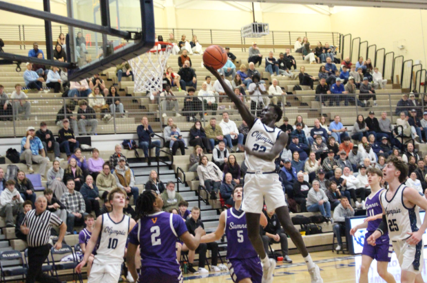 Elijah Buol dunks against Sumner. The boys basketball team practices upwards of 15 hours per week during the season, a massive time commitment for the athletes. 